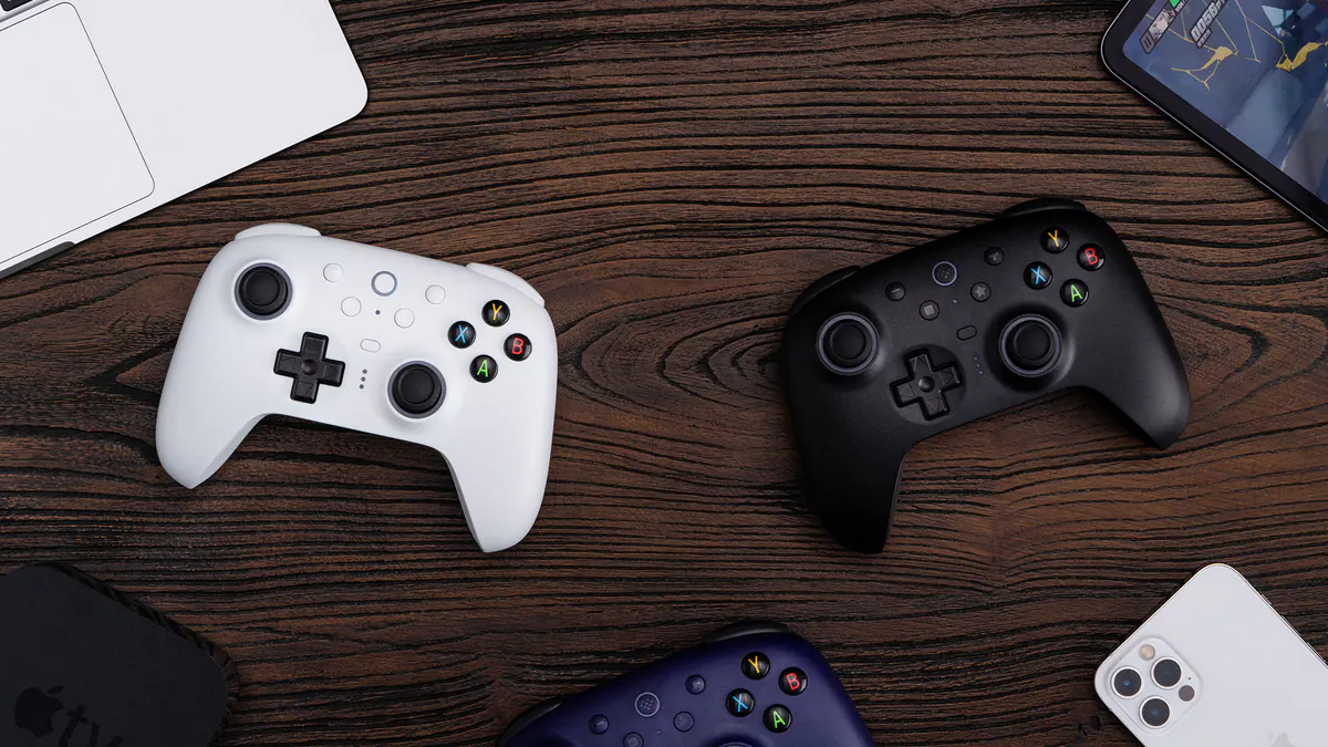 8BitDo Ultimate 2 Wireless Controller white and black controllers on a desk