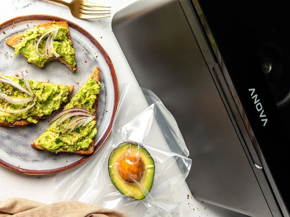 Vacuum-sealed avocado beside Anova chamber sealer