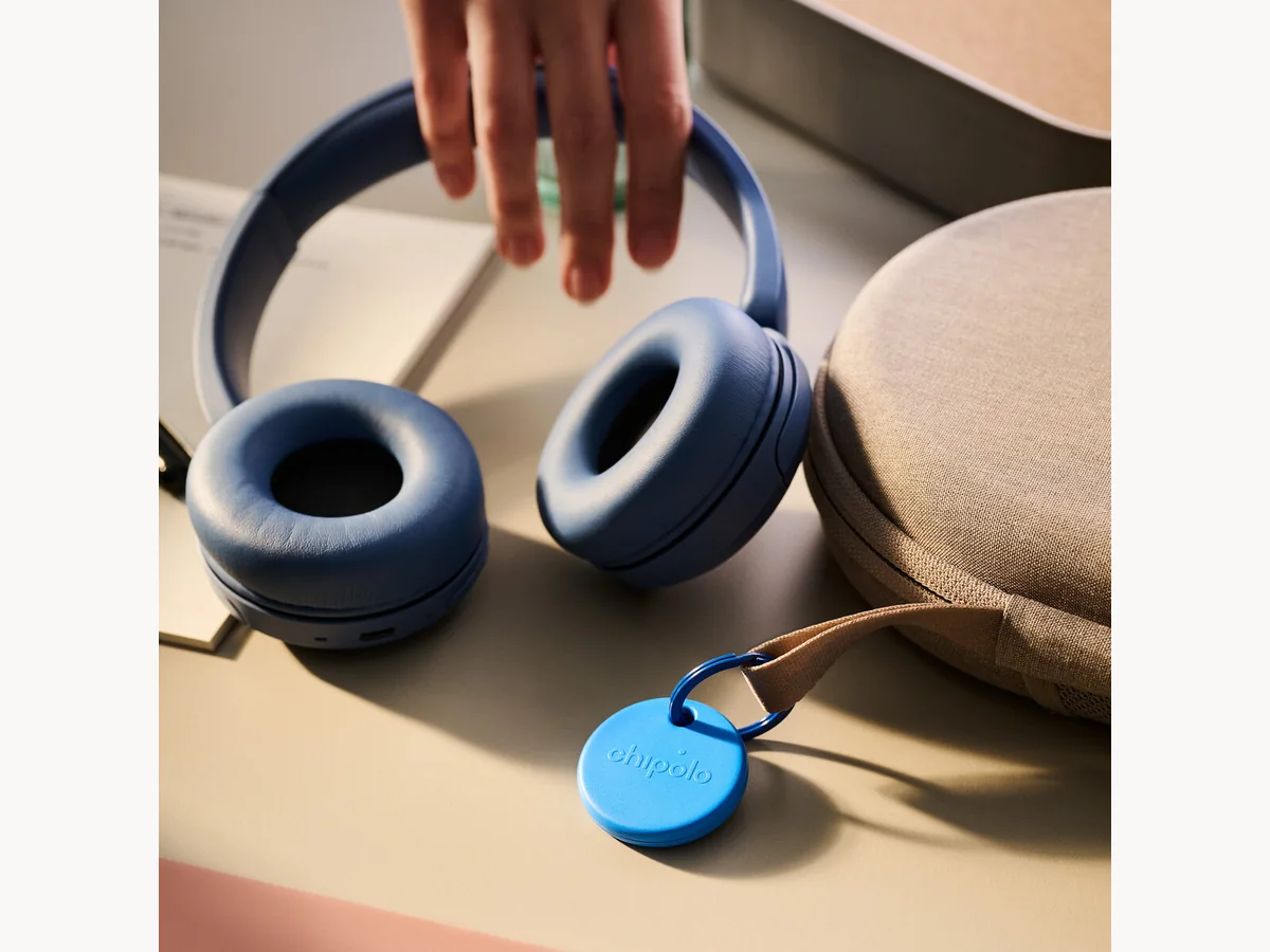 Chipolo POP attached near a pair of headphones