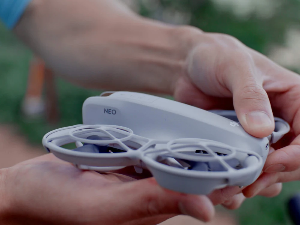 DJI Neo being held in one hand before launch