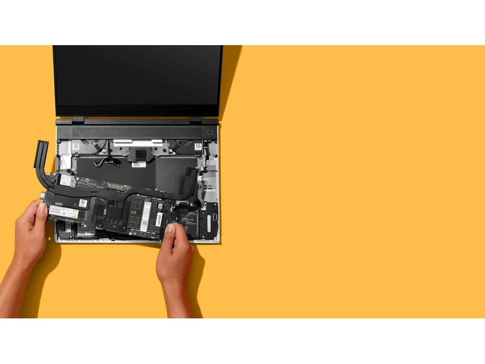 Framework Laptop 16 open for service on a yellow background
