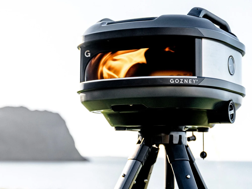 Gozney Tread Portable Pizza Oven firing on its stand outdoors