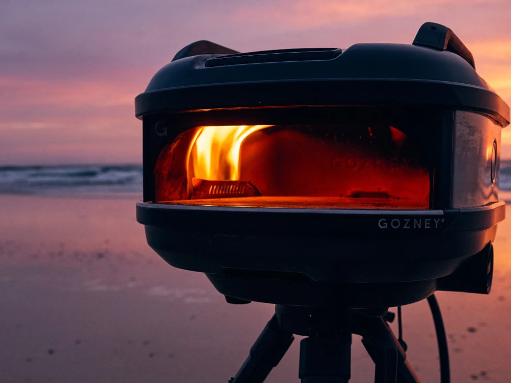 Gozney Tread Portable Pizza Oven glowing at sunset