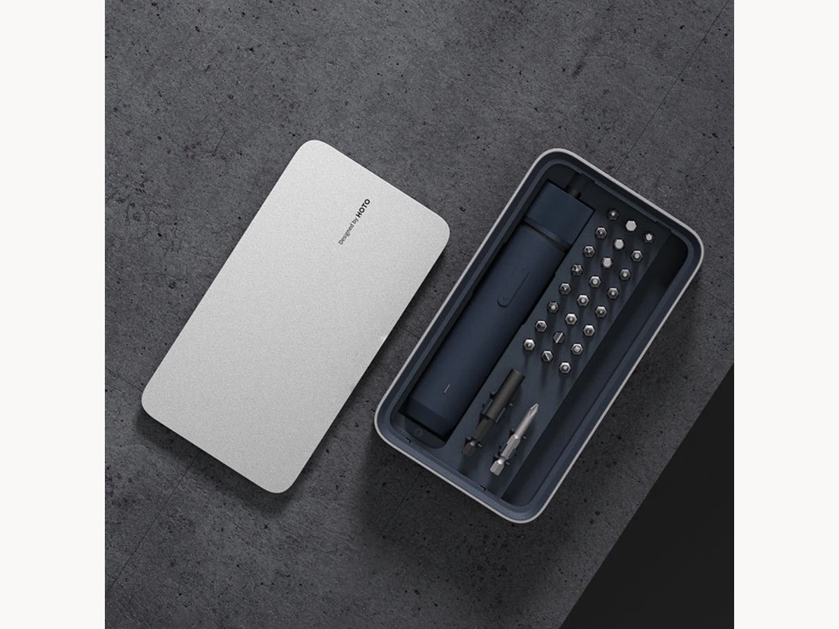 HOTO Electric Screwdriver Kit Pro open on a dark textured surface with its case lid beside it
