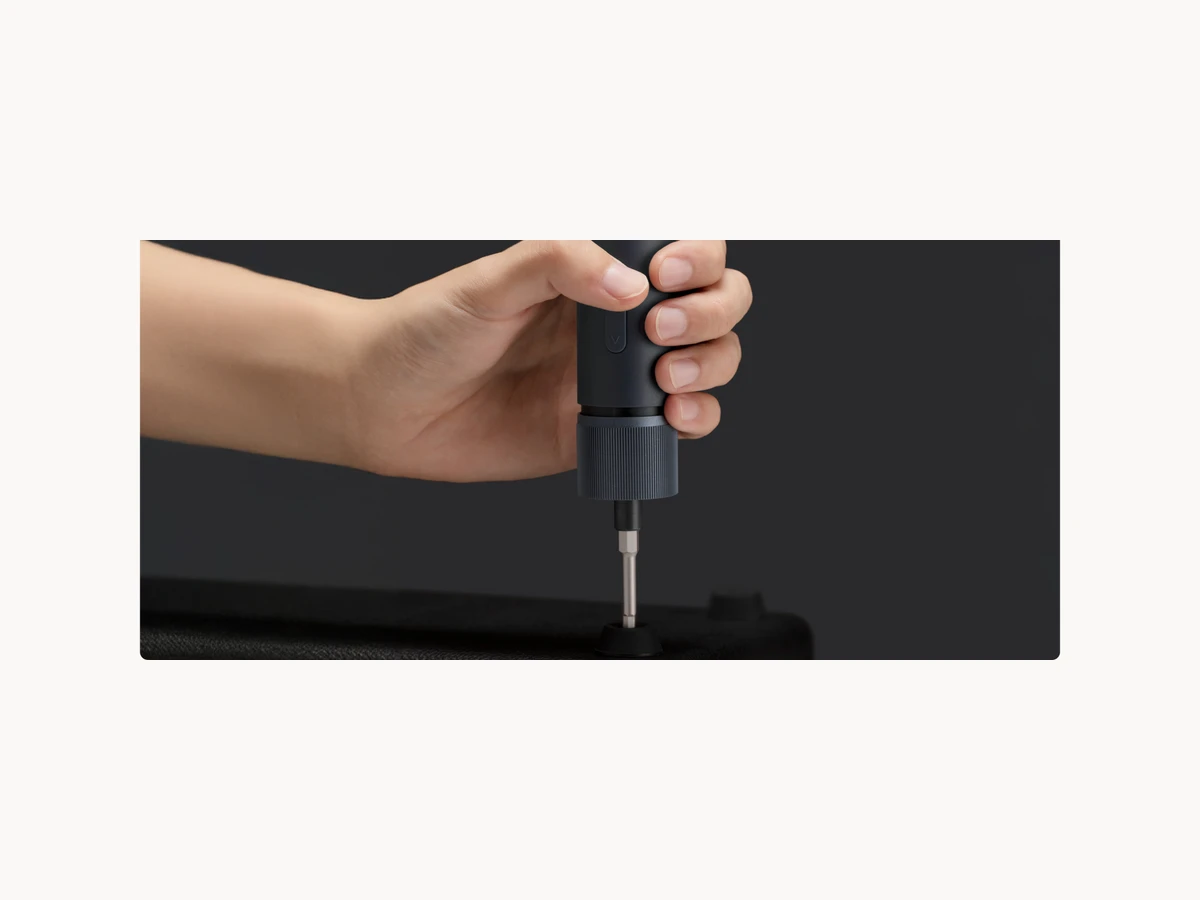HOTO Electric Screwdriver Kit Pro being used vertically on a dark appliance panel