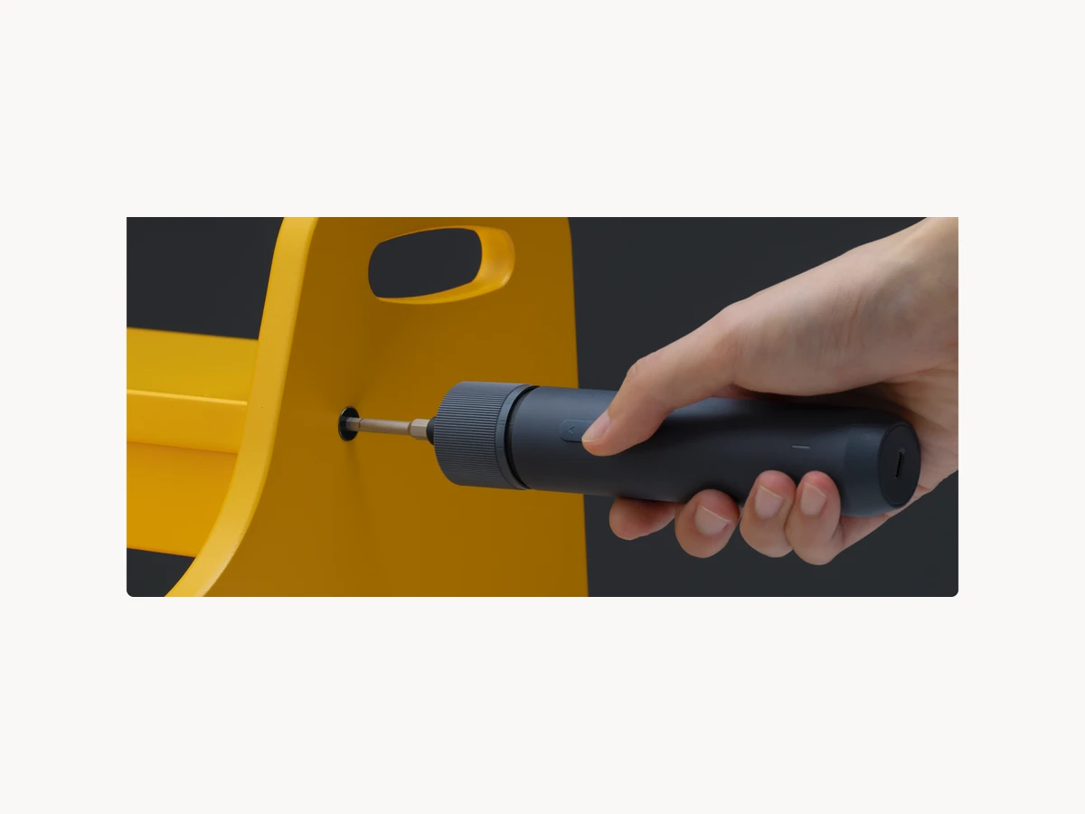 HOTO Electric Screwdriver Kit Pro driving a screw into a yellow home item
