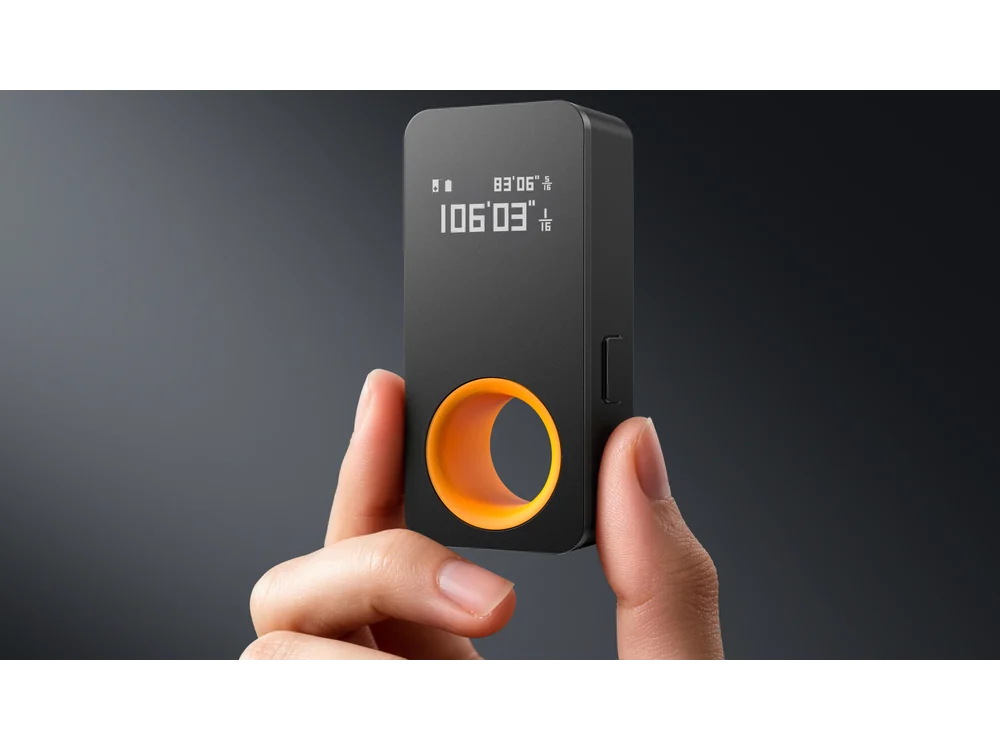 HOTO Laser Measuring Tool held upright showing its OLED display