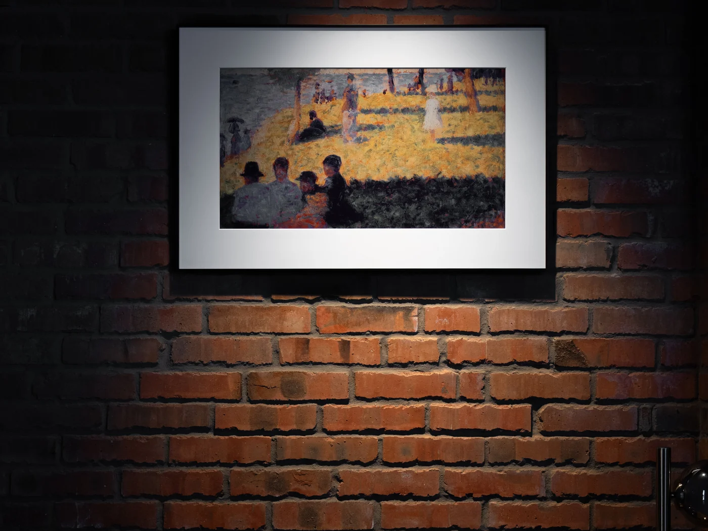 InkPoster display lit above a brick wall