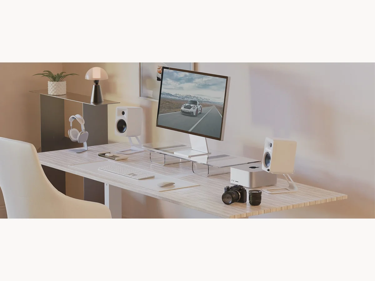 White Kanto ORA4 speakers on a styled desk setup