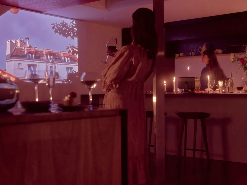 Leica Cine Play 1 projector beside a sofa during movie night