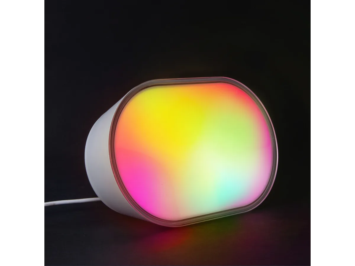 LIFX Luna glowing with multicolor light on a dark surface