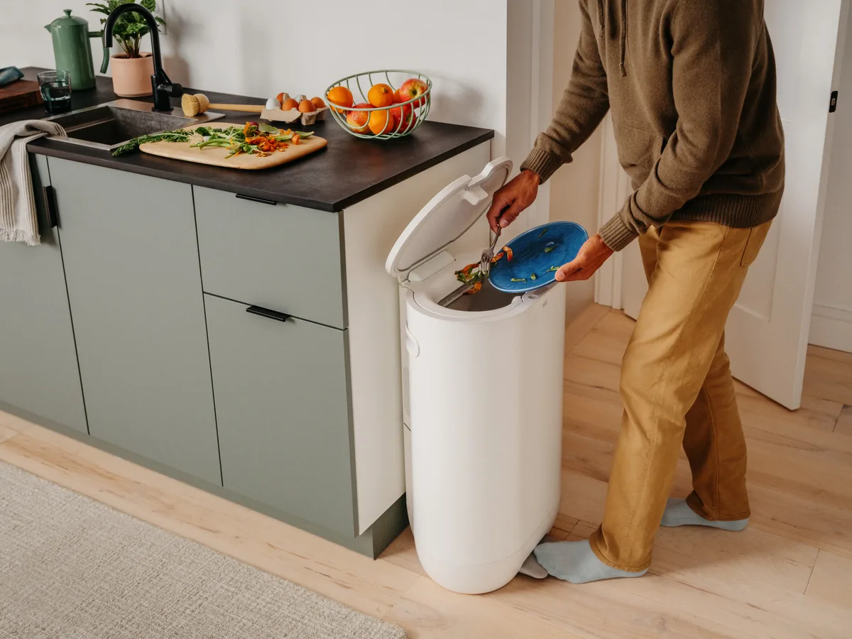 Mill Food Recycler open beside a kitchen counter