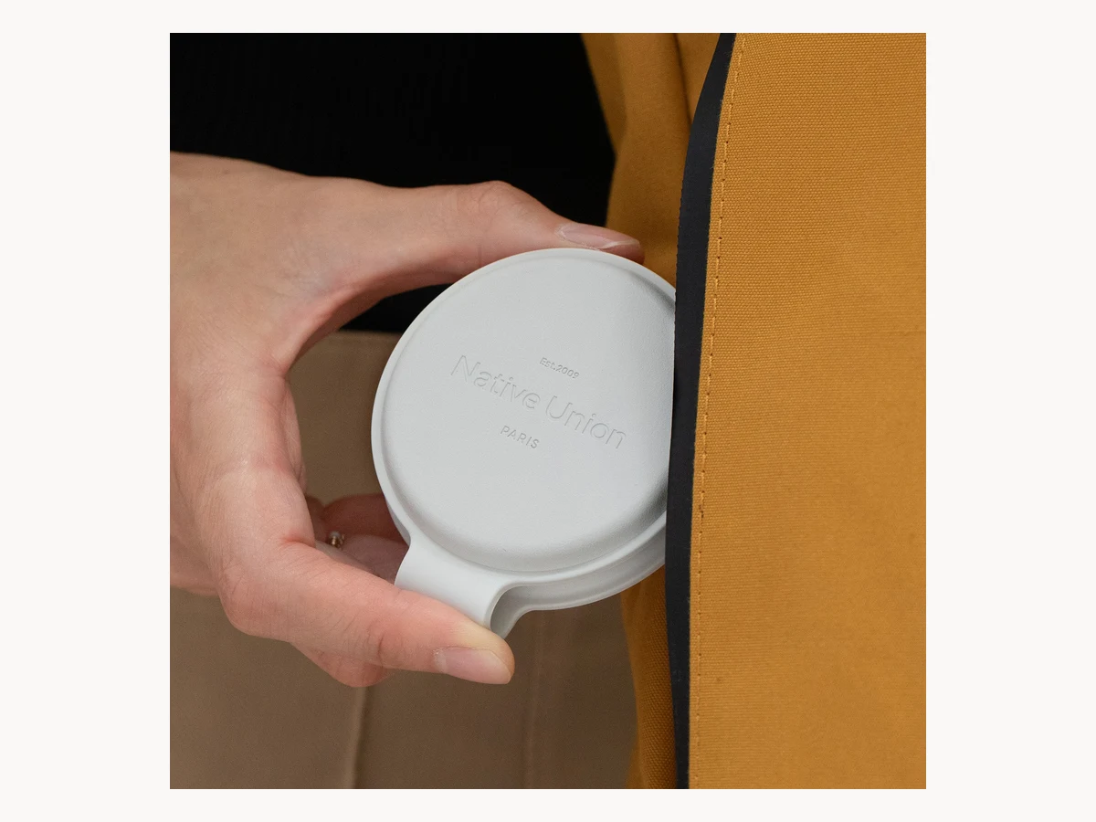 Native Union Voyage charger being placed against a wall outlet