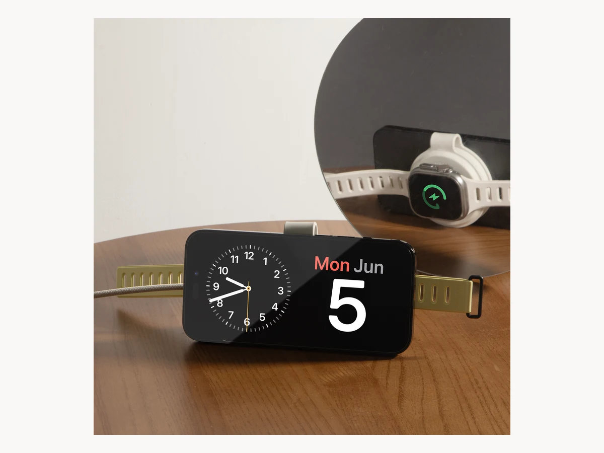 Native Union Voyage charging an iPhone and watch on a bedside table