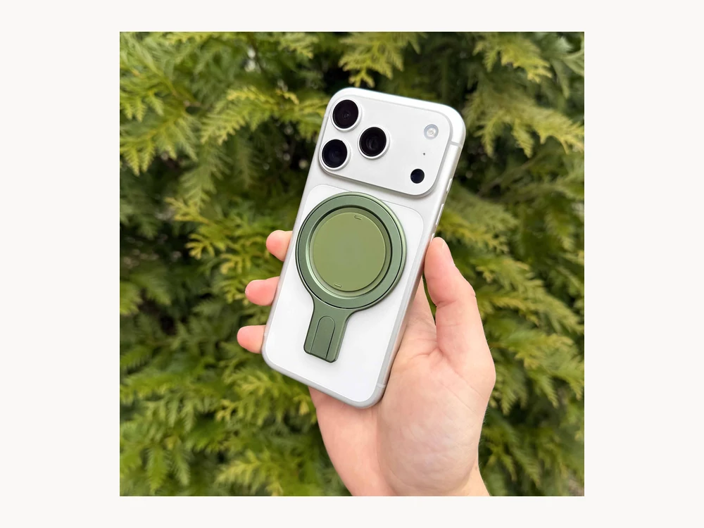 Green Ohsnap Snap Grip Stand on a white iPhone