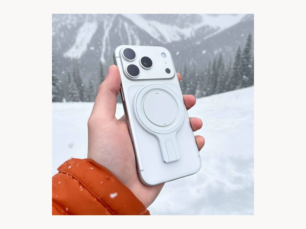 White Ohsnap Snap Grip Stand on a phone in snowy outdoor setting