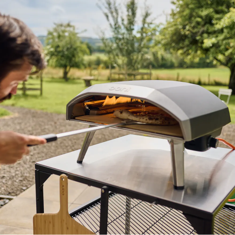 Ooni Koda 16 Gas Pizza Oven outdoor table setup with pizza peel