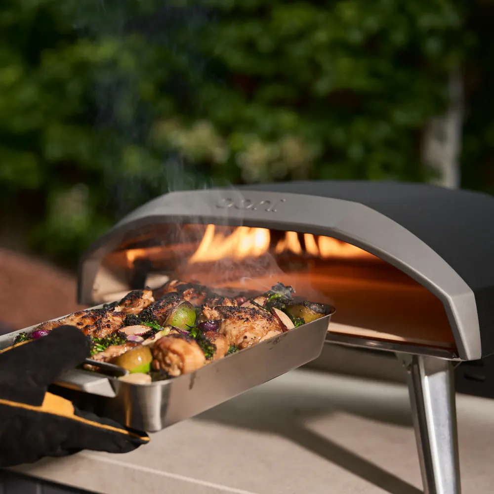 Ooni Koda 16 Gas Pizza Oven cooking food over open flame