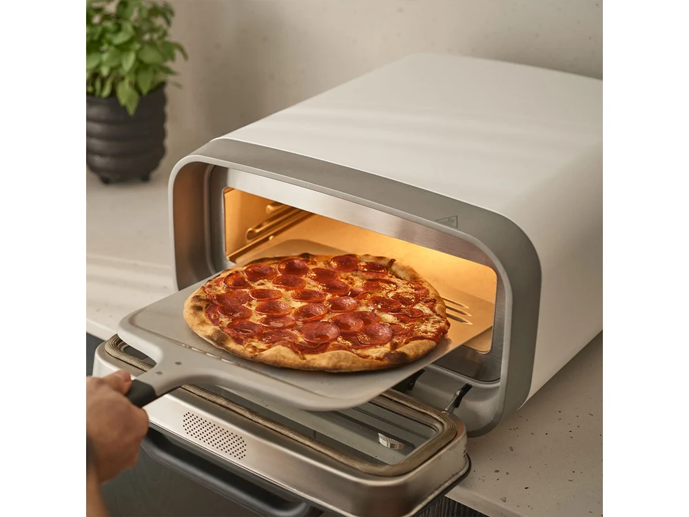 Ooni Volt 2 baking pizza on the counter