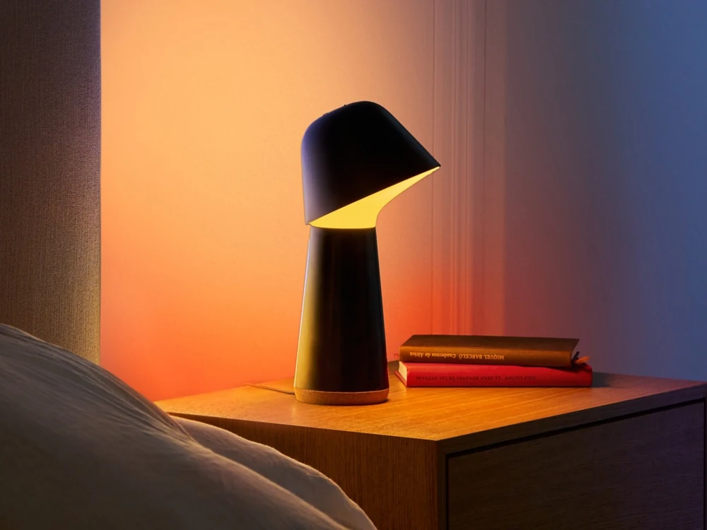 Philips Hue Twilight lamp glowing warm on a bedside table