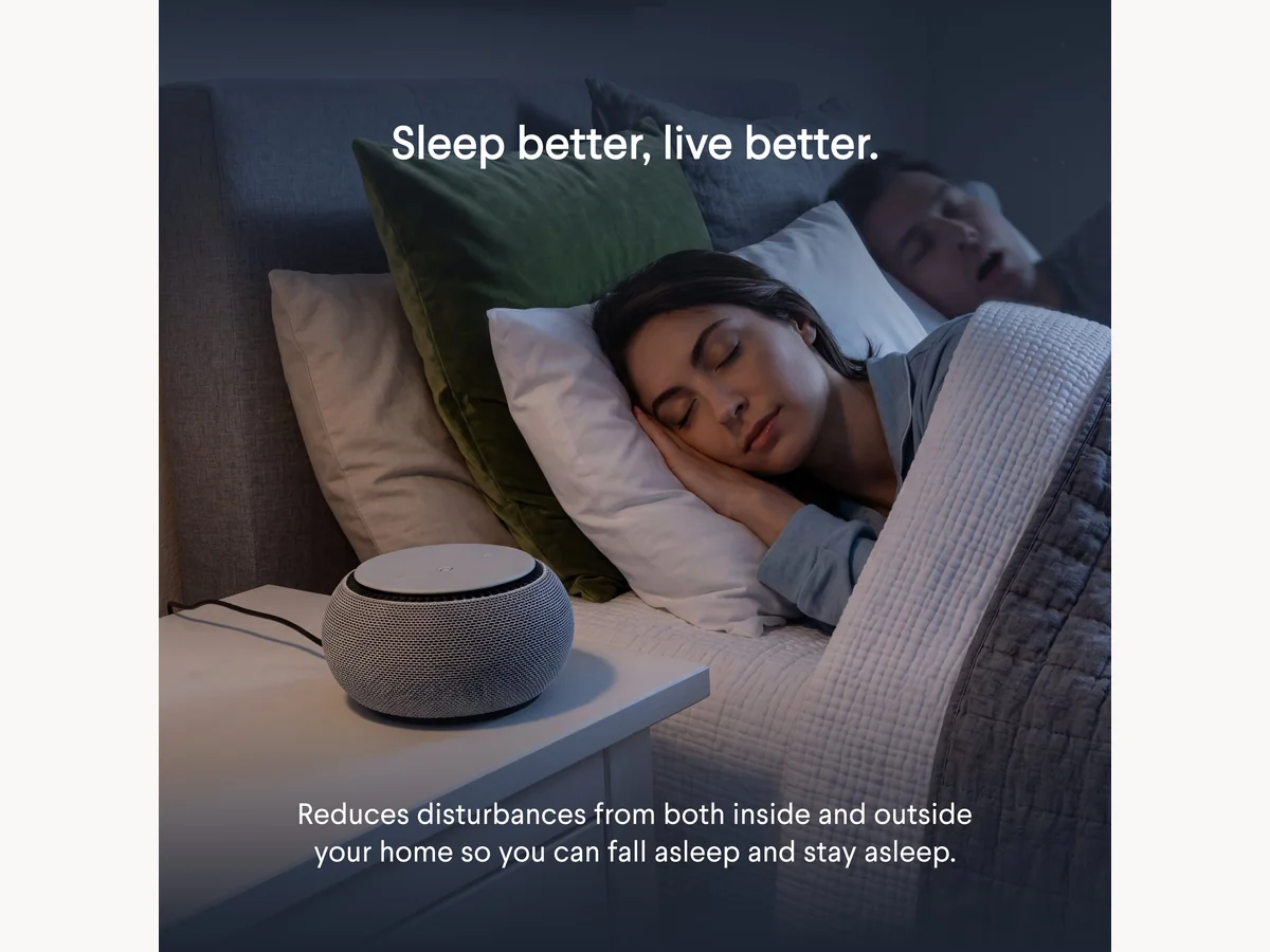 SNOOZ white noise machine on a bedside table