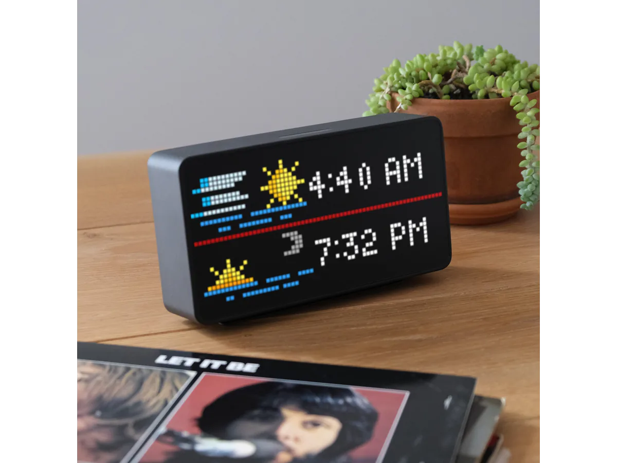 Tidbyt Gen 2 pixel display on a shelf showing weather and time widgets