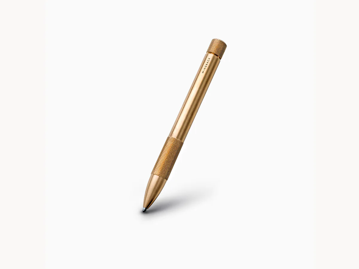 Wingback Mechanical Pen in brass on a clean light background