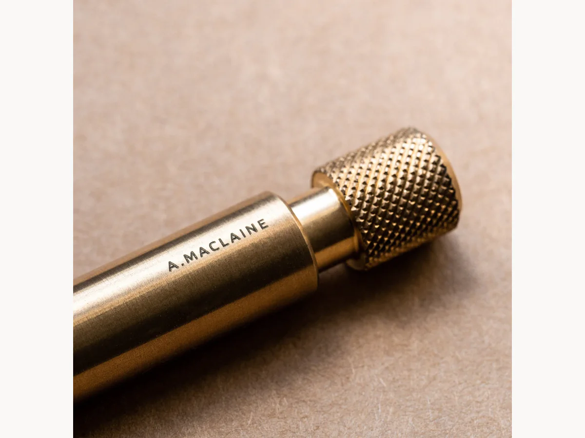 Close-up of personalized Wingback brass pen barrel and knurled cap